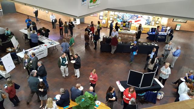 Attendees gathering in the atrium between sessions